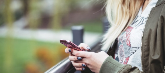 Person using smartphone in text-based therapy session
